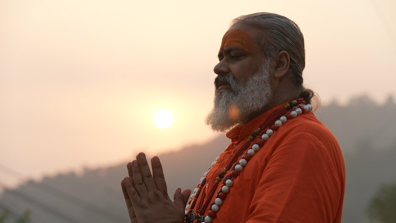 Baba Ji praying at sunset